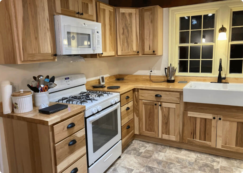 The newly renovated kitchen with wood-burning stove gone and new cabinets!